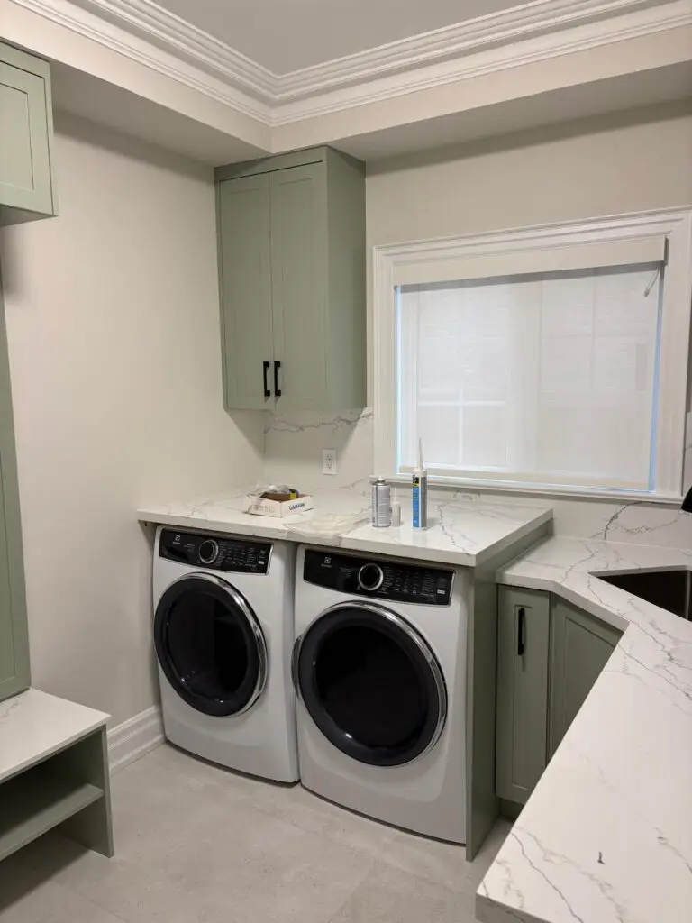 Custom laundry room cabinets with quartz countertop and shaker doors