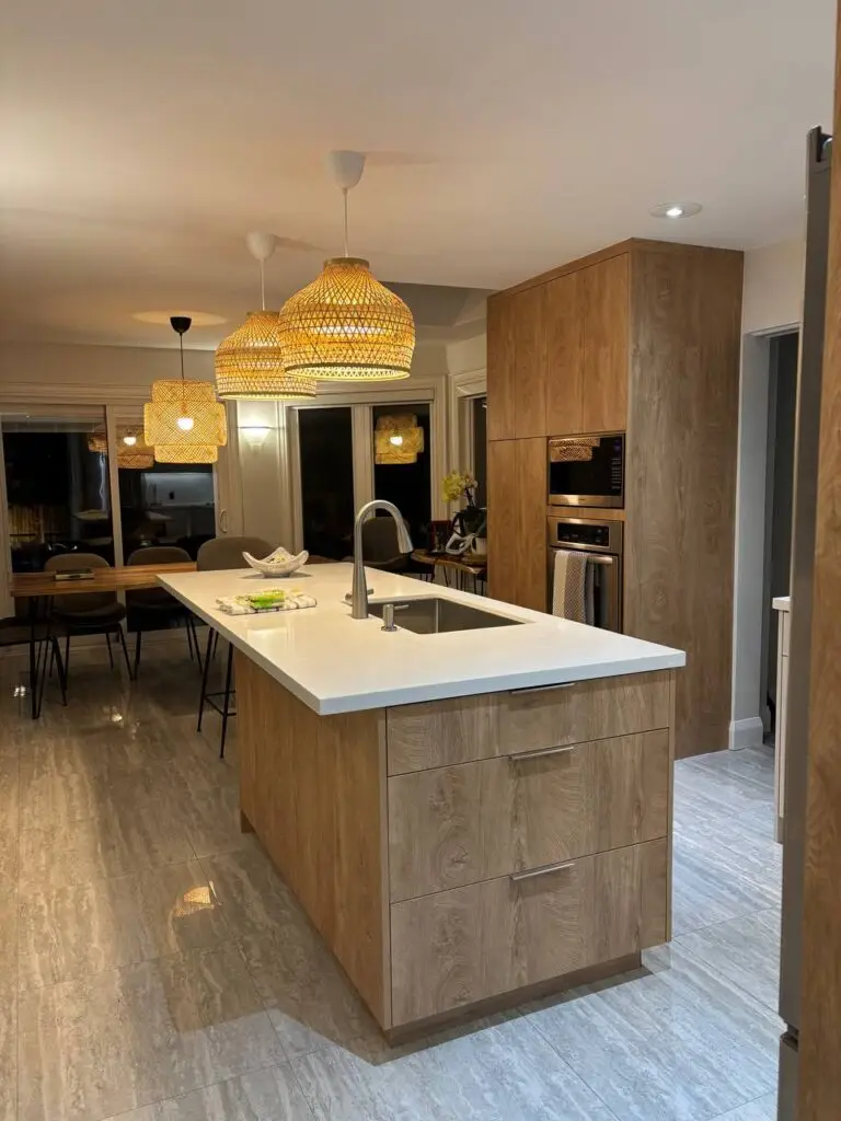 Custom kitchen storage solutions with pull out bin and organizer