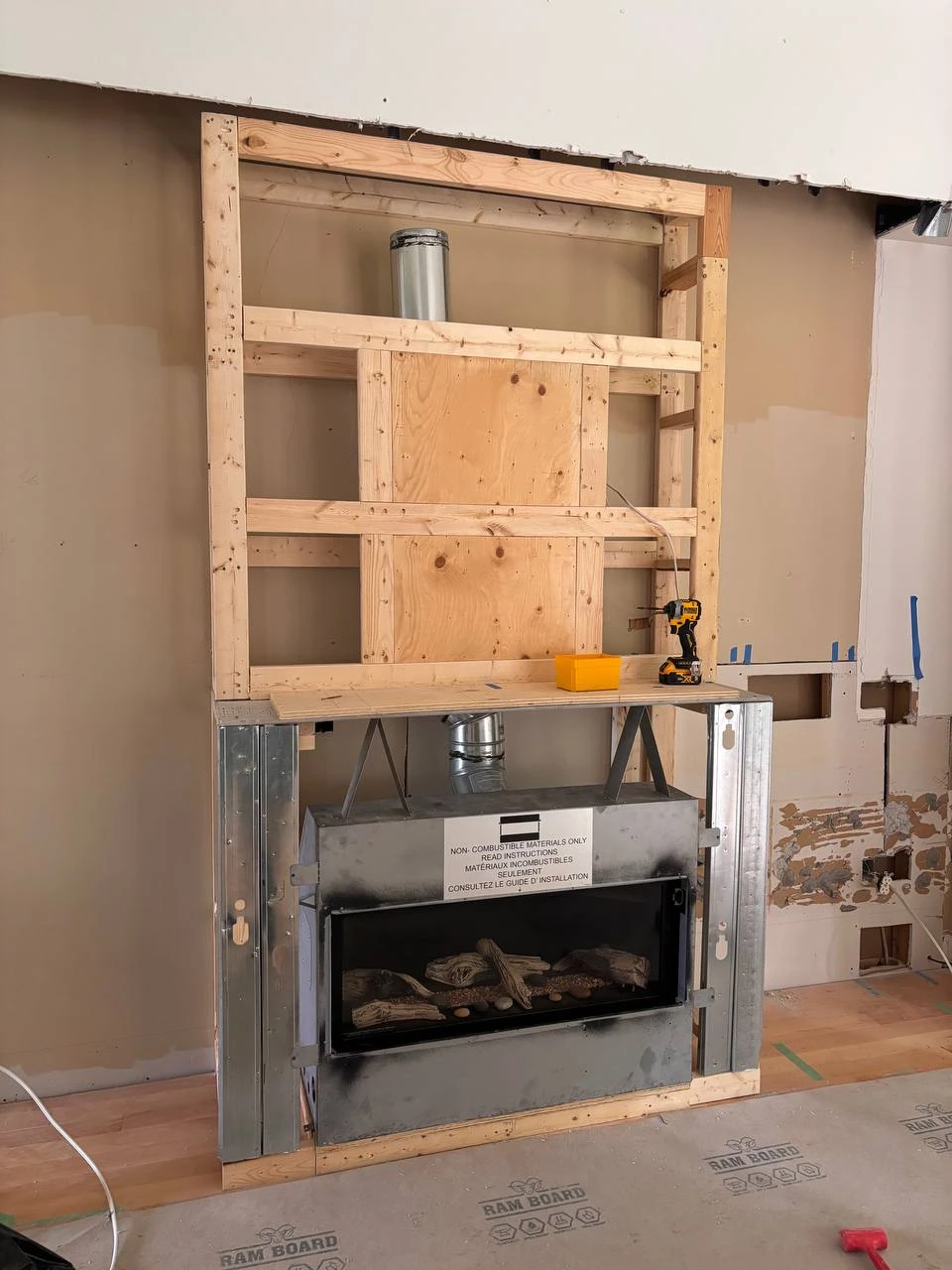 Gas fireplace and venting exposed during framing for the Ballantrae media wall