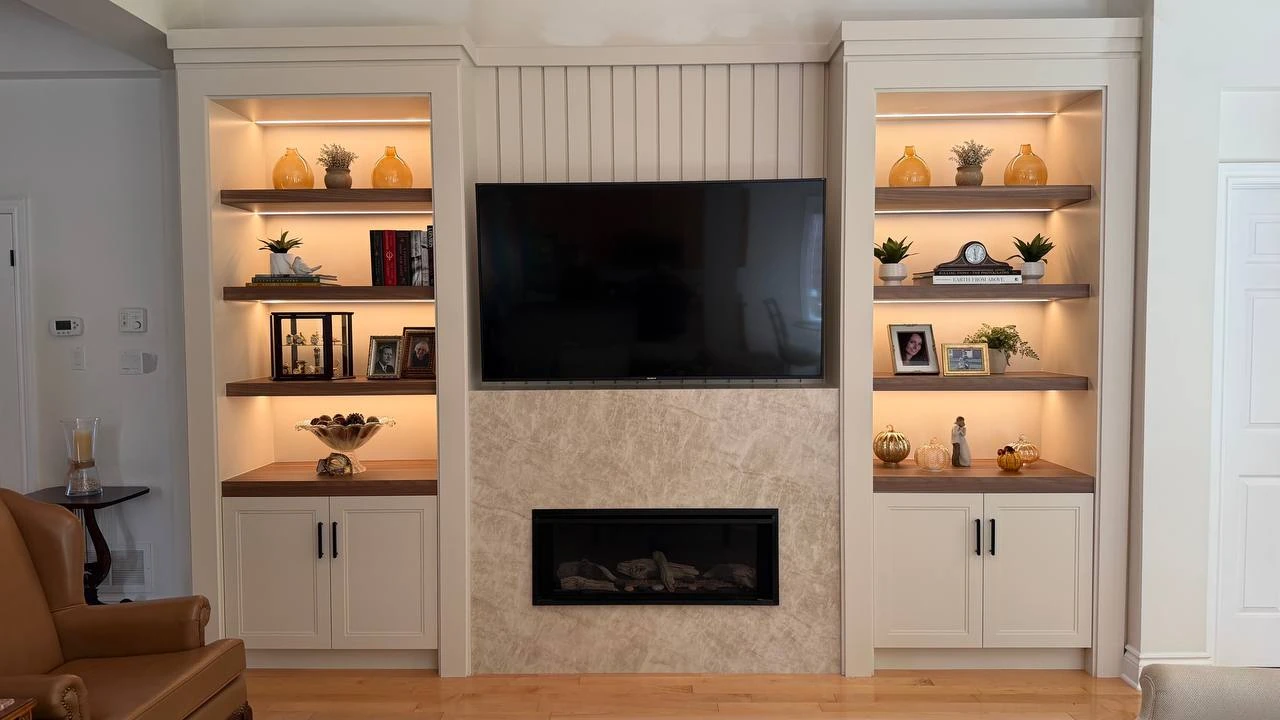 Completed Ballantrae media wall with illuminated shelves, closed storage and a central gas fireplace